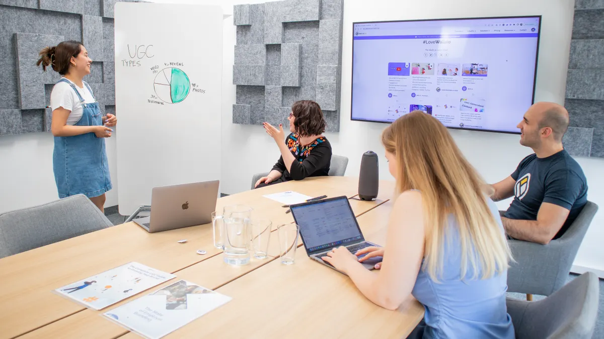 small team meeting in a conference room with board and screen