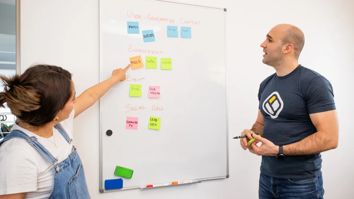 How to Map Roles and Responsibilities in AI Blog Production Two coworkers mapping tasks on a whiteboard with sticky notes