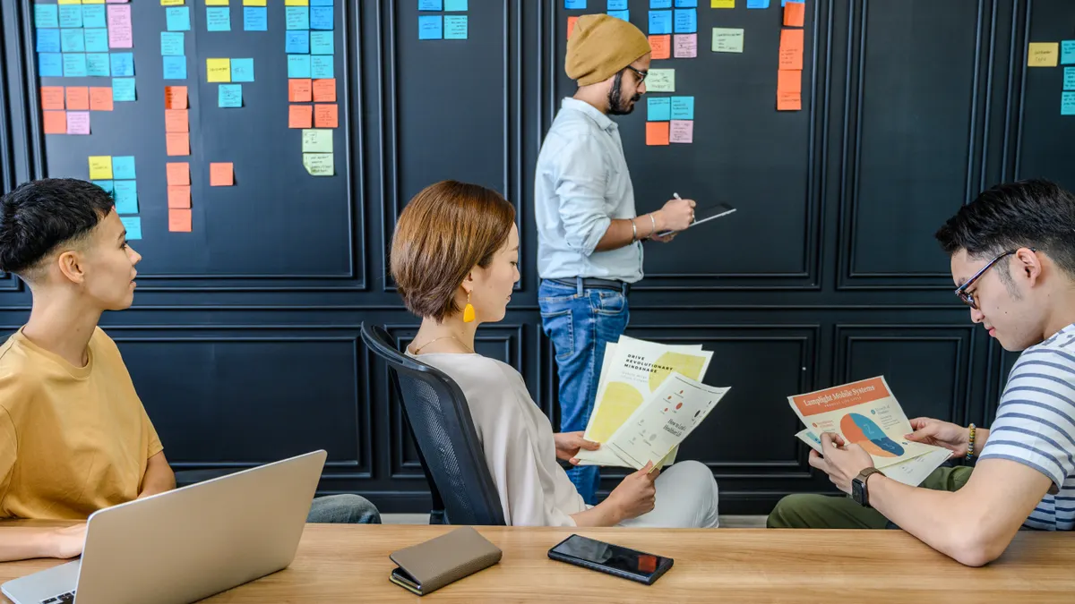 Team planning work with sticky notes on a wall