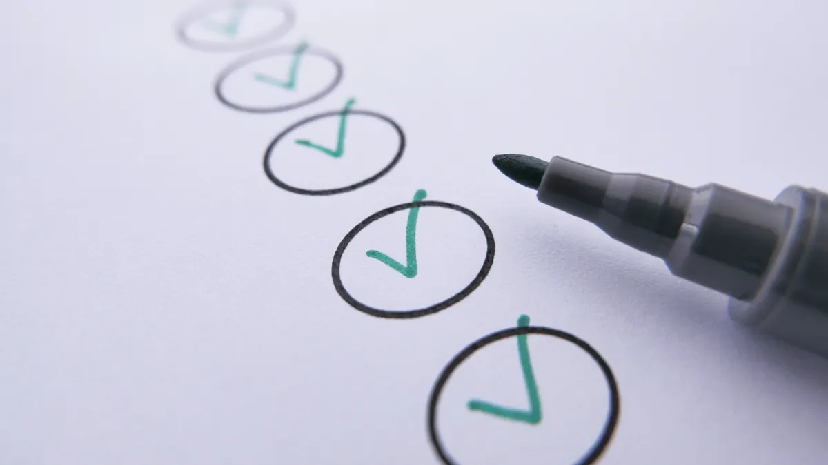 Pen beside circled check marks on paper